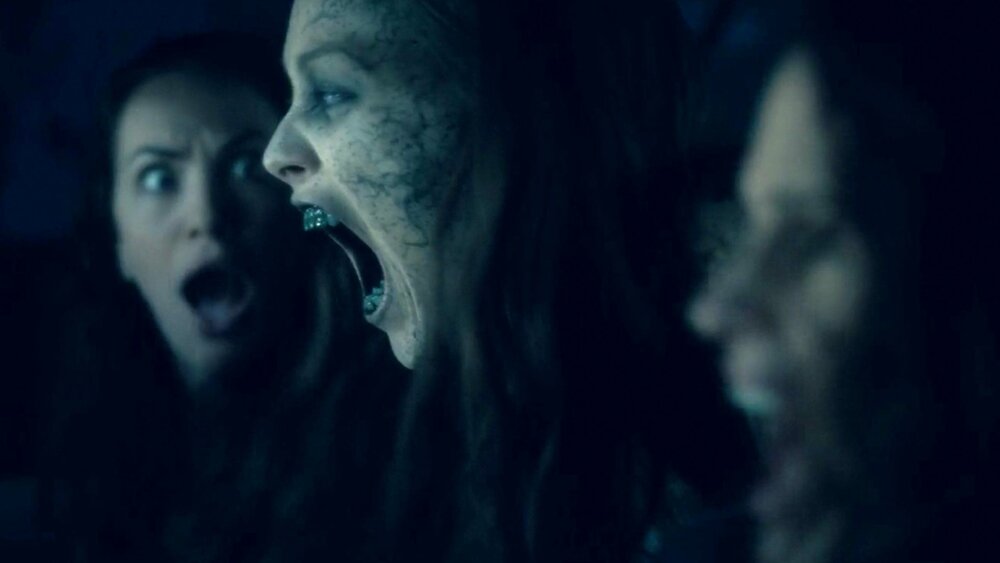 The Haunting Of Hill House Season 2 Quick Spoilers What Will Happen To Abigail Release Date three-people-standing-in-front-of-a-creepy-looking-house-with-dark-clouds-behind-them-and-the