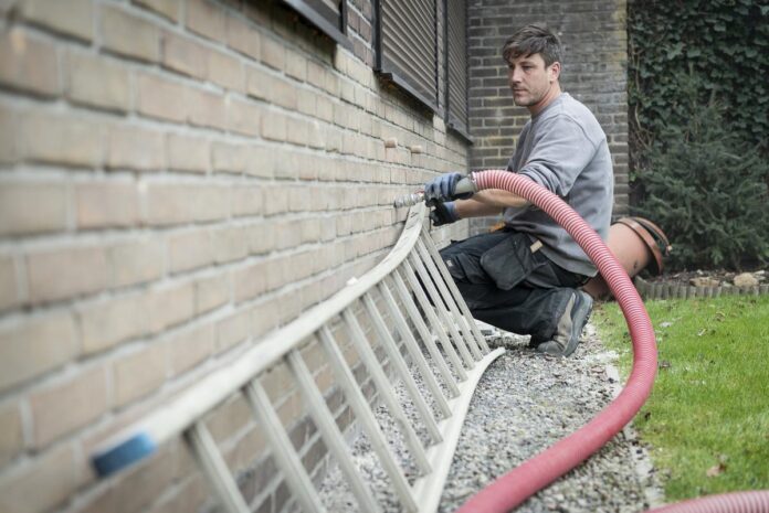 Cavity Insulation Issues - Worker Setting up Cavity Insulation in A Home