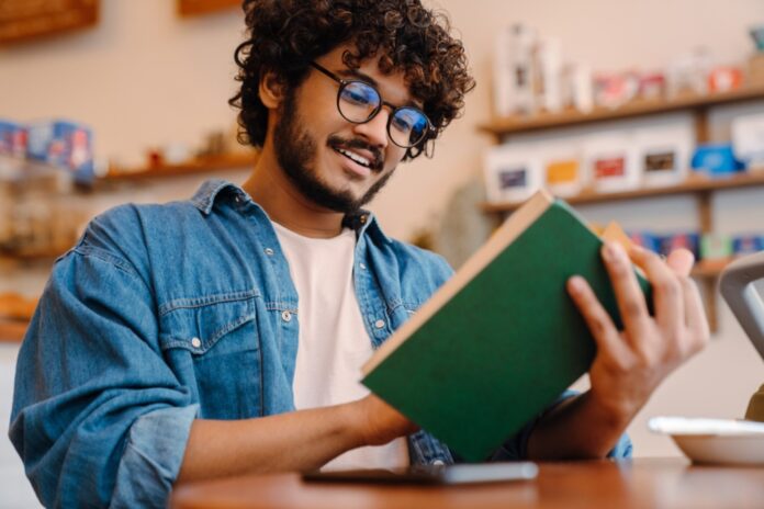 A student reading a self-assurance book.