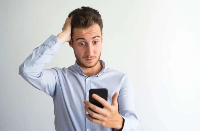 confused person looking at phone