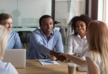 Onboarding Best Practices: Building a Strong Foundation for Employee Success Black ceo handshaking with woman financier while sitting at meeting