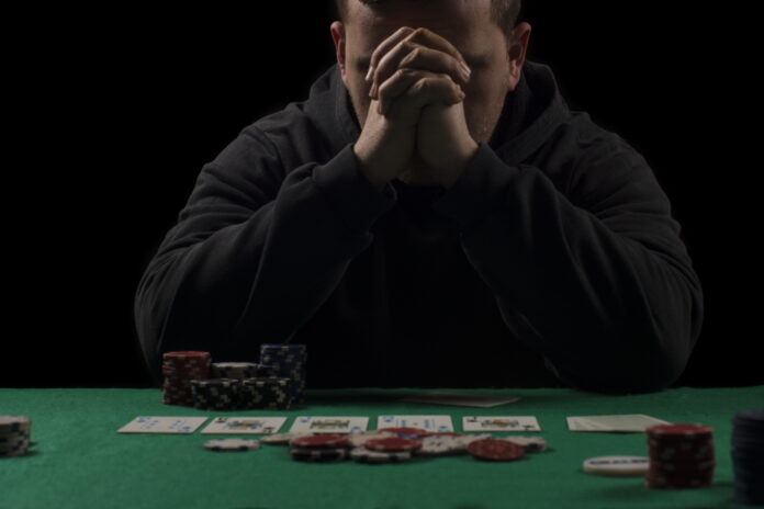 Poker table setup. Man sitting at a table in casino